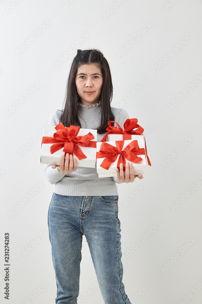 Fototapeta premium Young woman happy hold gift box in hands