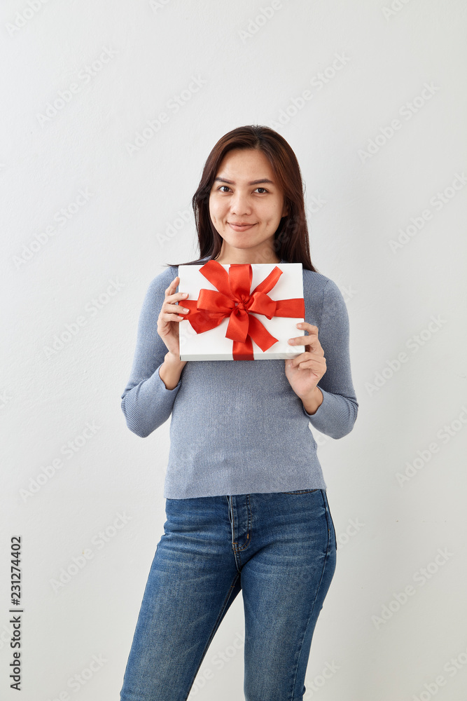 Fototapeta premium Young woman happy hold gift box in hands