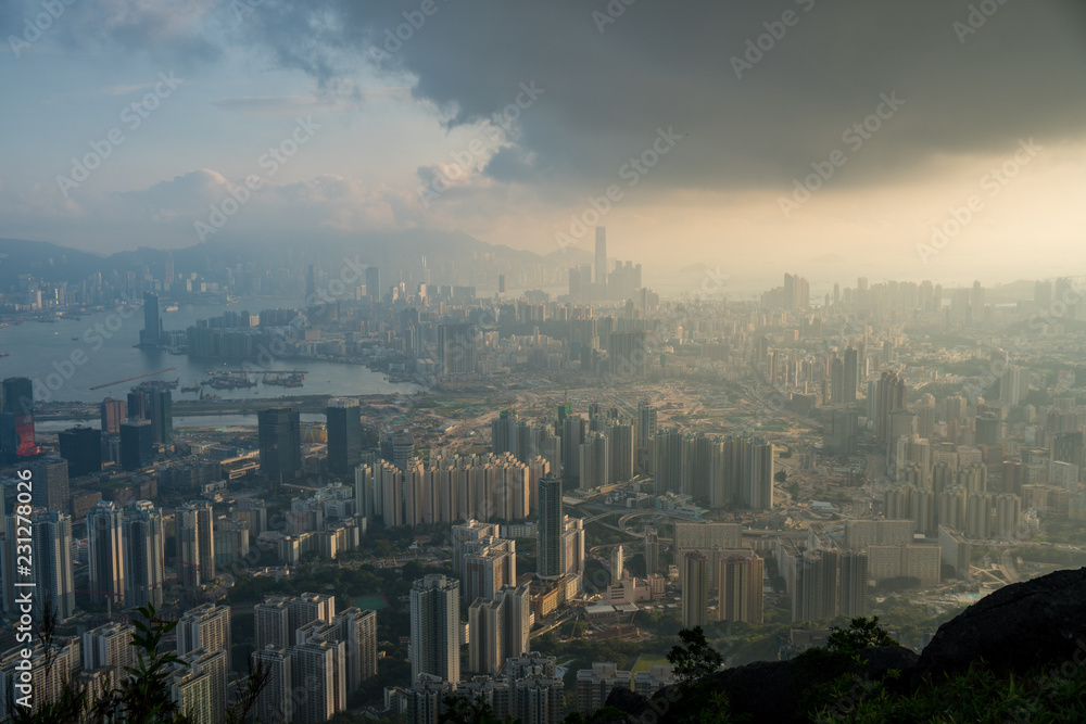 Beautiful afternoon light over Hong Kong at sunset. Modern Chinese city, viewed from above