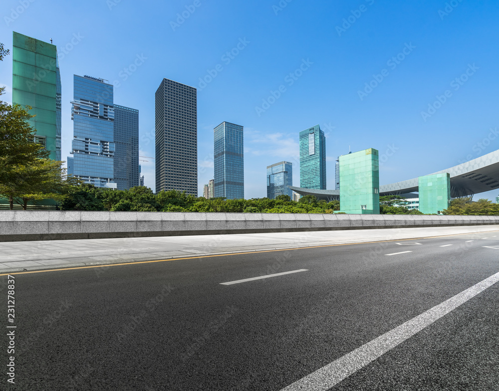 empty asphalt road with city skyline background in china. empty asphalt road with city skyline background in china.