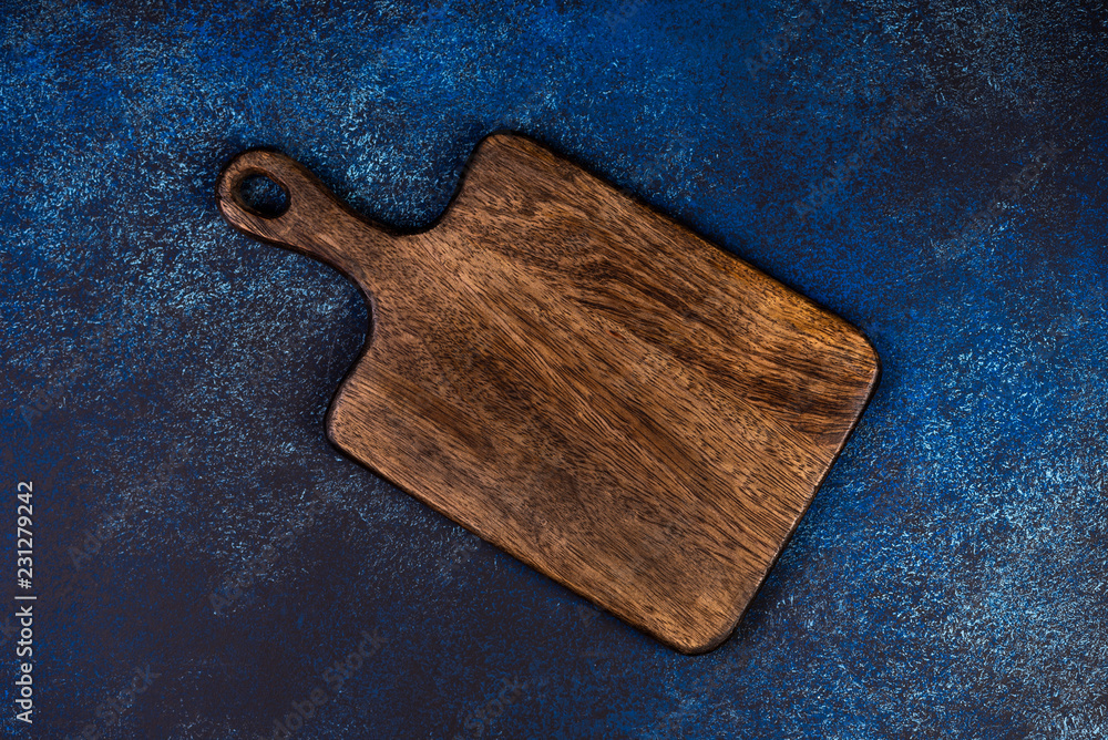 Cutting board on a blue background, top view