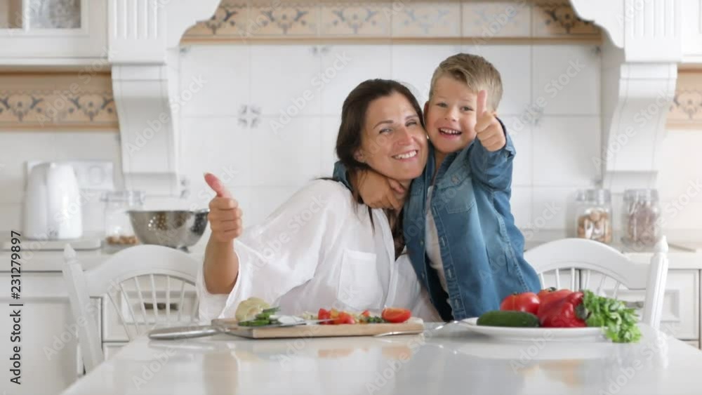 Portrait happy mother and smiling little son having fun together showing cool gesture thumbs up Portrait happy mother and smiling little son having fun together showing cool gesture thumbs up