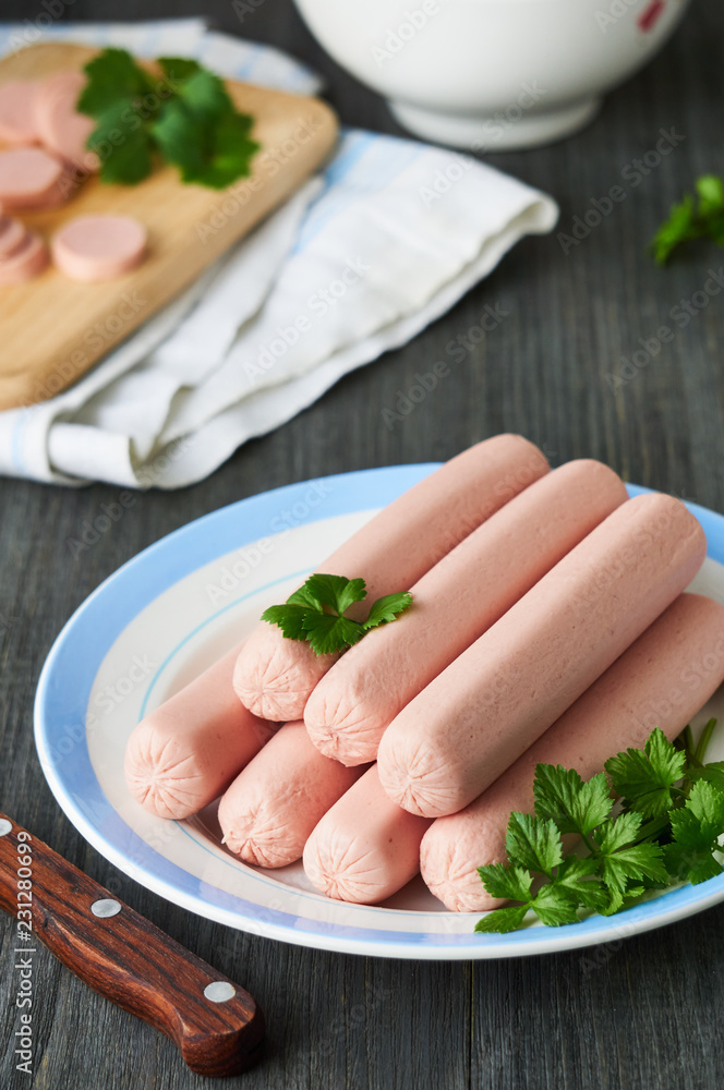 Raw sausages with parsley on a plate Raw sausages with parsley on a plate