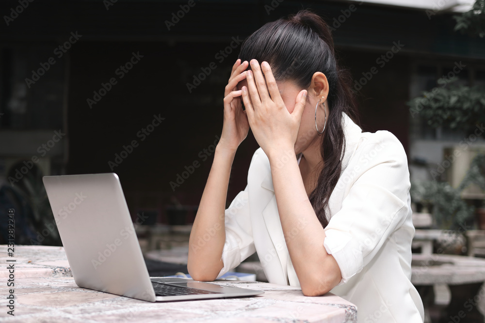 Frustrated stressed young Asian business woman with hands on face suffering from severe depression. Frustrated stressed young Asian business woman with hands on face suffering from severe depression.