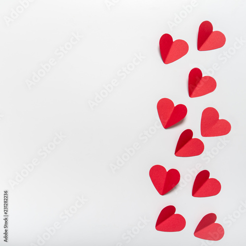 red paper hearts on white background