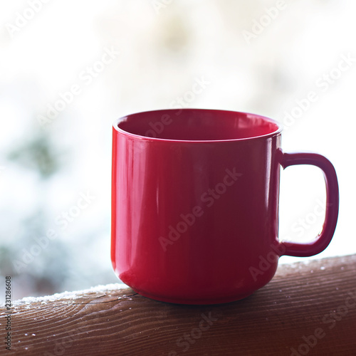 Cup with coffee, tea on the background of the winter landscape