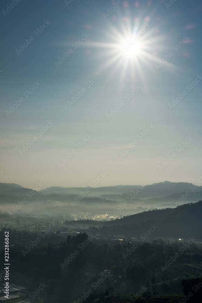 Sunny and foggy morning at village under the hill Sunny and foggy morning at village under the hill