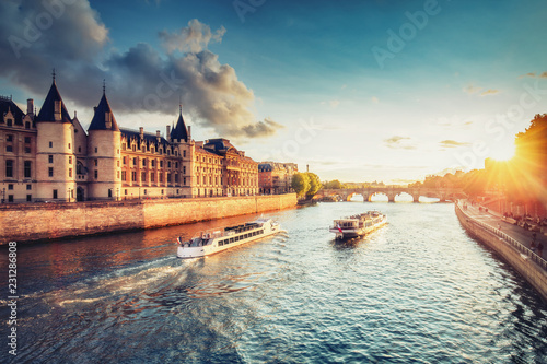 Dramatic sunset over Cite in Paris, France, with Conciergerie, Pont Neuf and river Seine. Colourful travel background. Romantic cityscape. © Funny Studio
