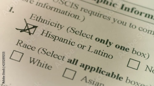 A pen selects hispanic or latino on a government immigration document