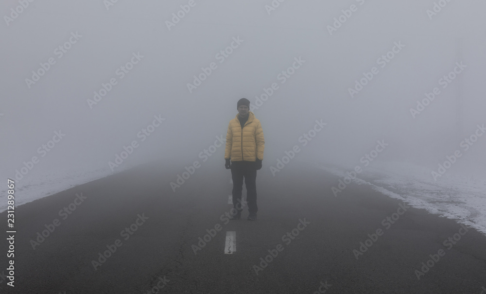 mysterious man walking in the mist by road mysterious man walking in the mist by road