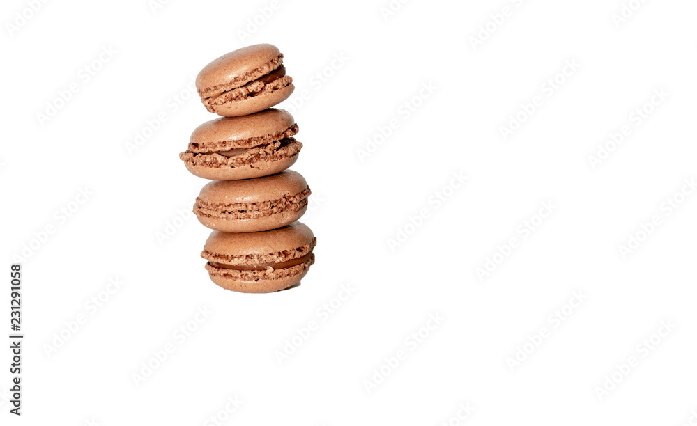 Stack of four freshly baked brown macaron cookies isolated on white background Stack of four freshly baked brown macaron cookies isolated on white background