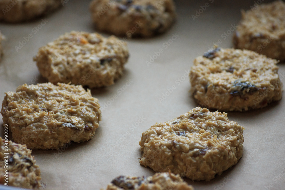 Oat cookies with raisins before bakery. Homemade food. Grey background. Cooking process. Oat cookies with raisins before bakery. Homemade food. Grey background. Cooking process.