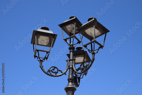 street lantern vintage optic, decorative and nostalgic street lamp in front of azure sky