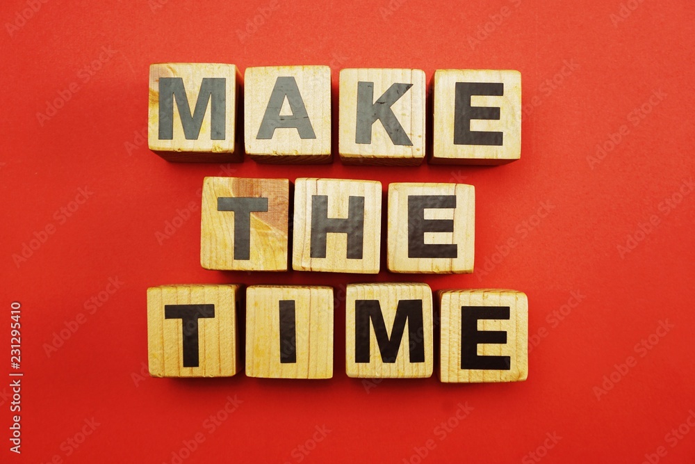 top view make the time letters alphabet wooden cubes on red background
top view make the time letters alphabet wooden cubes on red background