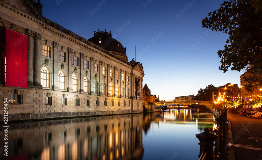 Fototapeta premium Museum illuminated, Spree river, museum island, Berlin, in the evening
