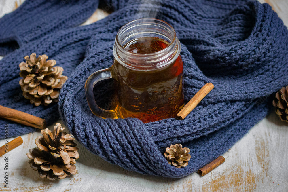 Autumn still life. cup of tea, Scarf and cinnamon sticks on wooden background. Autumn still life. cup of tea, Scarf and cinnamon sticks on wooden background.