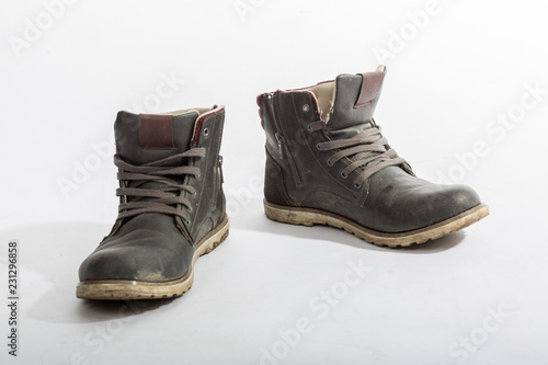 Two old dirty shoes isolated