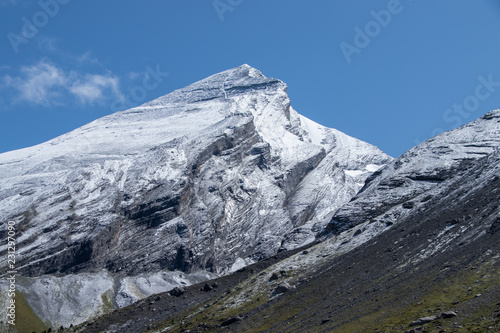 Mountain peak covered in first snow in autumn
