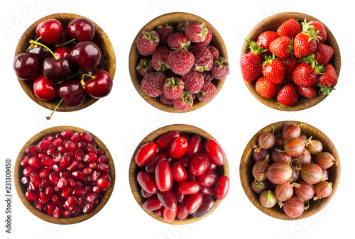 Collage of red fruits and berries isolated on white. Set of strawberries, cherries, raspberries, cornels, gooseberries and pomegranate seeds. Sweet and juicy berry with copy space for text. 