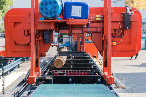 woodworking enterprise. Wood Cutting Machine. Partially milled log on a portable lumber milling machine.