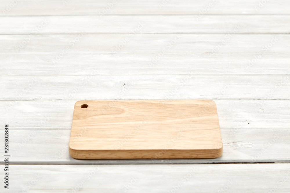 Cutting board top view on wooden background