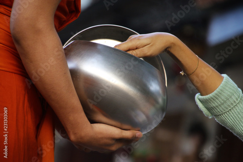 Monks recept  alms in the streets of Luang Prabang, Laos photo