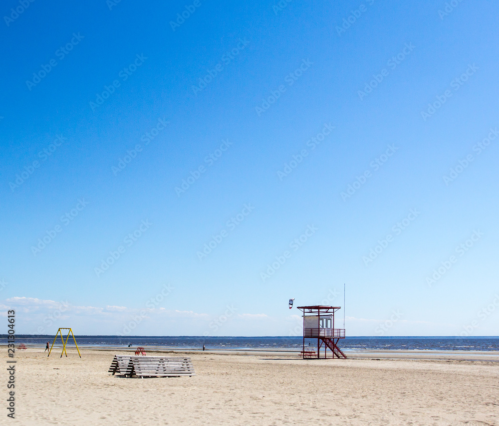 chairs on beach with lifeguard tower