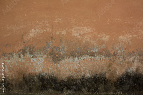old pink beige wall with black spots and scratches