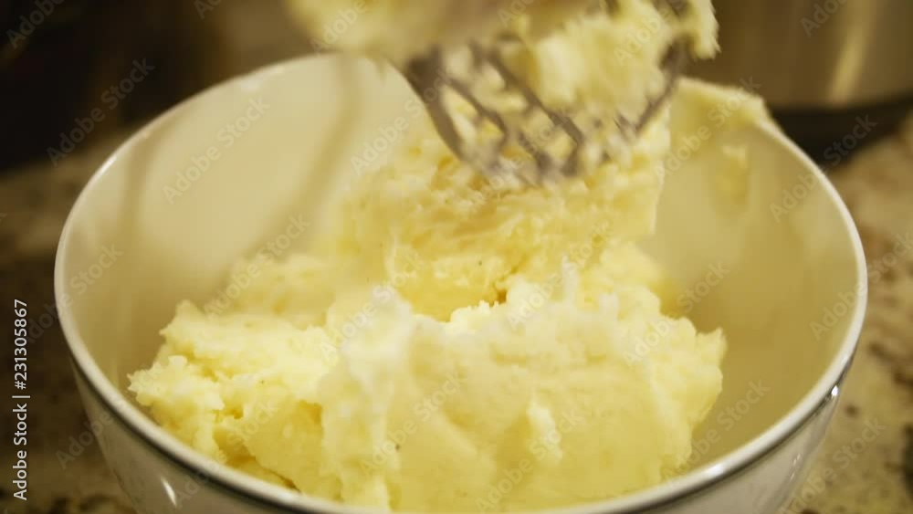 Authentic Freshly Mixed Mashed Potatoes being Transfered to Serving Bowl Authentic Freshly Mixed Mashed Potatoes being Transfered to Serving Bowl