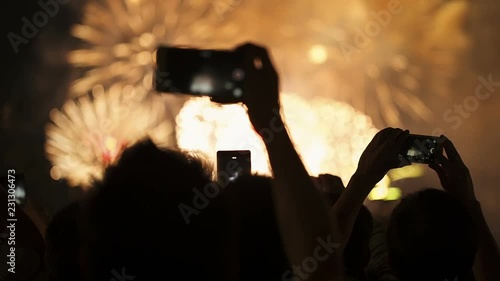 Firework, public, smartphones. Holiday backgrounds. Fireworks in the sky celebrating lunar new year.