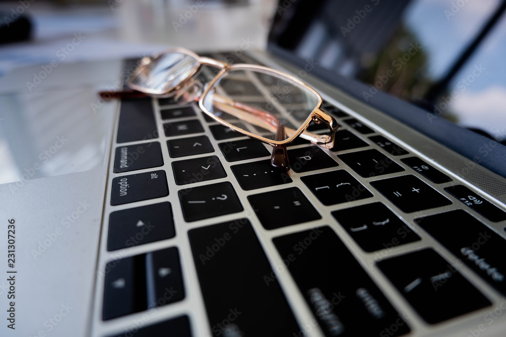 Business concept, glasses on laptop