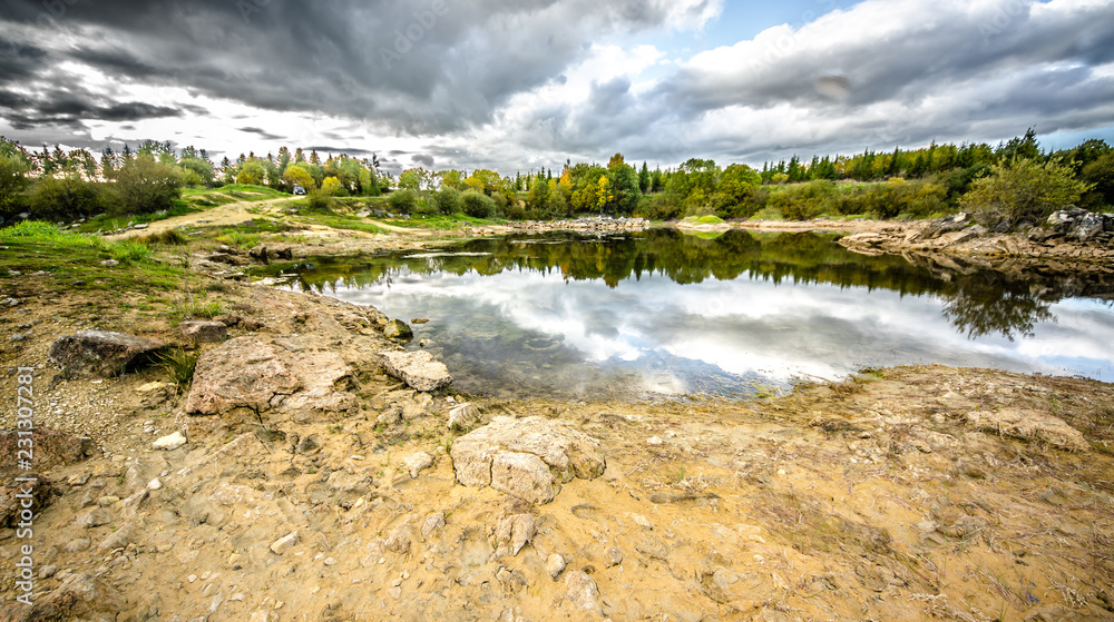 Sandy hills. Lake in the Sandy canyon. Warm colors background. Yellow sandstone textured mountain, white thin sand dune, bright sky. Sunshine landscape Sandy hills. Lake in the Sandy canyon. Warm colors background. Yellow sandstone textured mountain, white thin sand dune, bright sky. Sunshine landscape