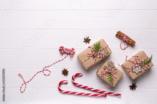 White christmas background. Framewith christmas gifts and candy cane, decorations , pine cones, fir branches top view photo