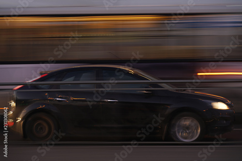 car blurred in motion, black. with city lights. long exposure © Alex