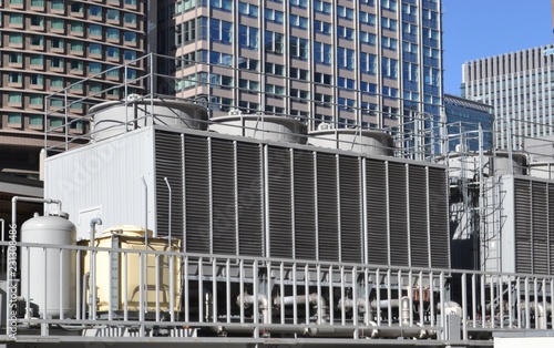 Cooling tower for HVAC system with coils and fins on display with backdrop on city buildings