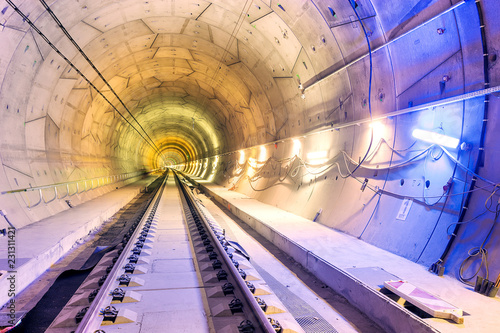Inside of railway tunnel illuminated by color lights. 