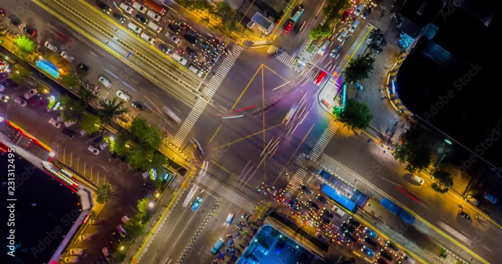 JAKARTA, Indonesia - October 31, 2018: Beautiful aerial hyperlapse of night traffic on the road intersection in Jakarta downtown, Indonesia. Shot in 4k resolution