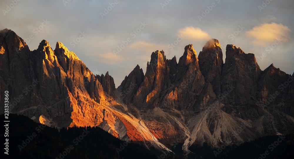 Beautiful idyllic mountain scenery in the Dolomites in golden evening light at sunset in fall colours, Val di Funes, South Tyrol, northern Italy