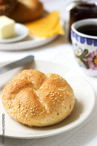 Breakfast with Kaiser rolls, currant jam, butter and cheese and tea.