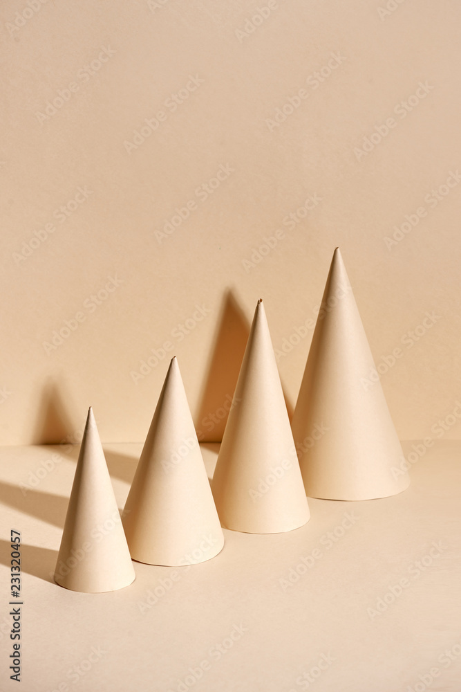 Creative Christmas tree made of paper on beige background Creative Christmas tree made of paper on beige background