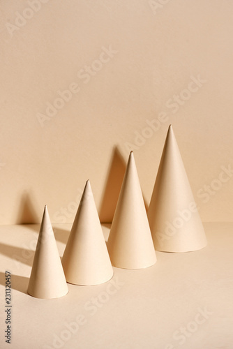 Creative Christmas tree made of paper on beige background