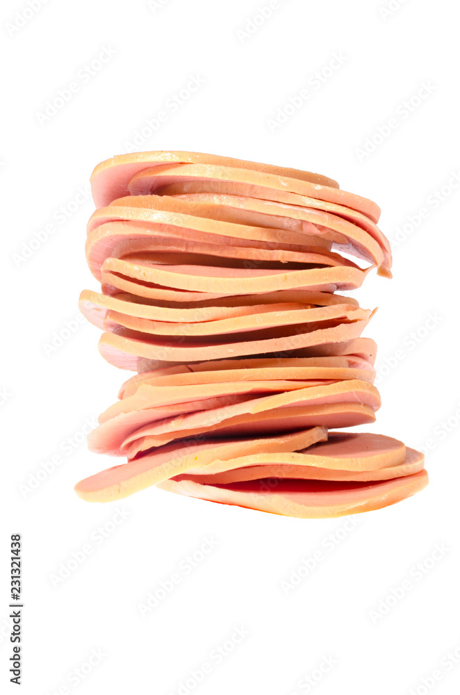 Round pieces of boiled unstructured sausage lined up in a tower isolated on white background.