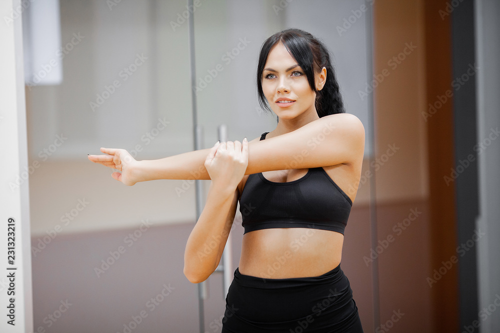 Concept of sport and healthy lifestyle. Cute brunette working out at a gym Concept of sport and healthy lifestyle. Cute brunette working out at a gym