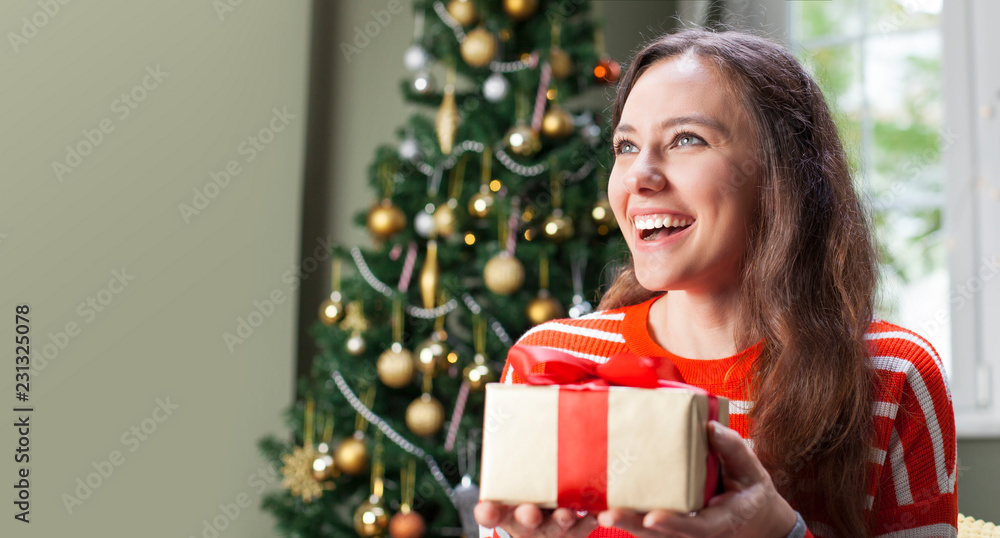 Young woman holding gift box