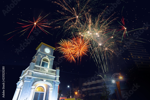 Colorful firework celebration..Fireworks displaying up in the sky over clock tower circle landmark of phuket town .. © sbw19