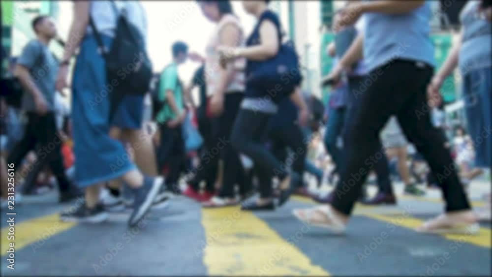 Anonymous crowd of pedestrians cross a busy city intersection on a summer evening. Pedestrians walkers. Slow motion shot. Urban lifestyle background. Anonymous crowd of pedestrians cross a busy city intersection on a summer evening. Pedestrians walkers. Slow motion shot. Urban lifestyle background.