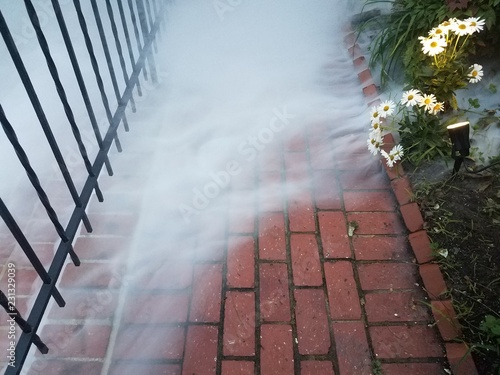 red brick sidewalk or path with smoke or fog