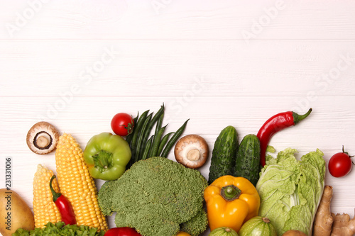 Different fresh vegetables on a wooden table top view. Proper and healthy food  diet  vegetarian. Cooking food  vegetable dishes. flat lay