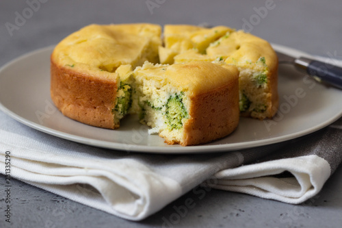 Corn cake with broccoli on parchment paper. 