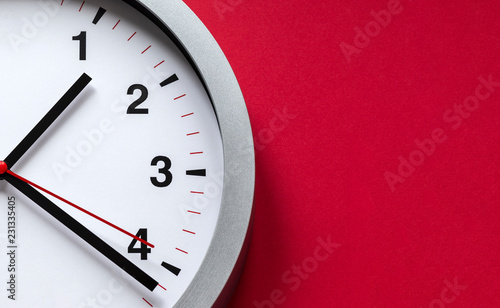 clock face on red background photo